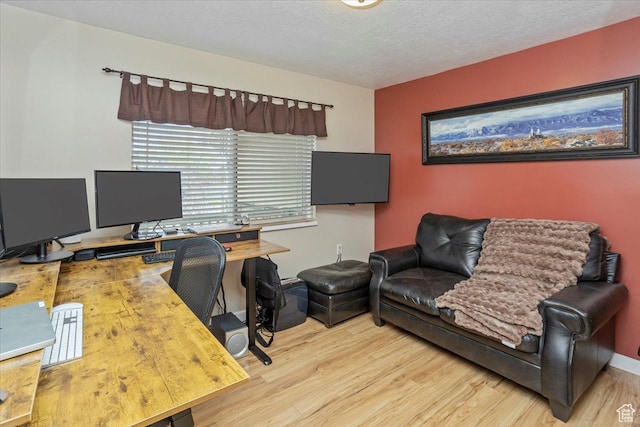 office space with wood finished floors and a textured ceiling