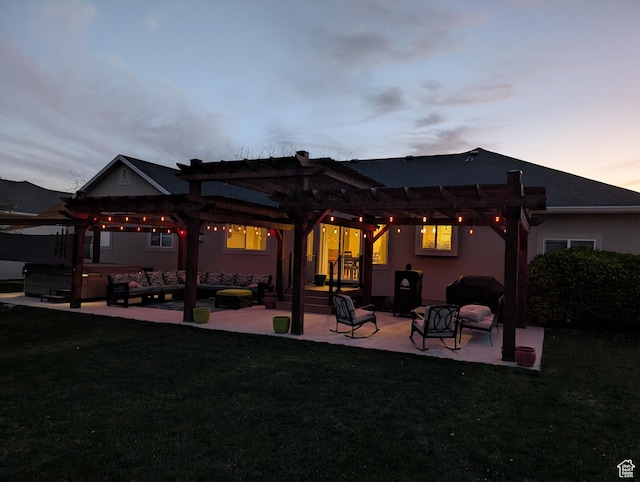 rear view of house featuring a pergola, a hot tub, stucco siding, a lawn, and a patio
