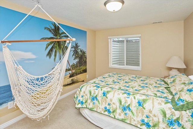 carpeted bedroom featuring baseboards and visible vents
