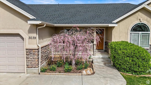 doorway to property with a shingled roof, stucco siding, and stone siding