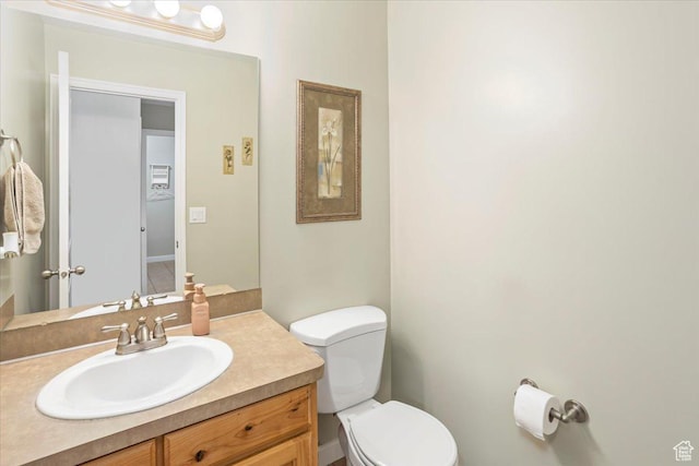 bathroom featuring vanity and toilet