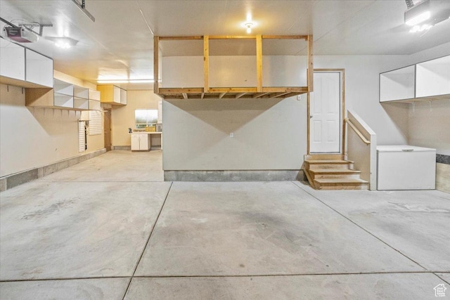 garage with fridge and a garage door opener
