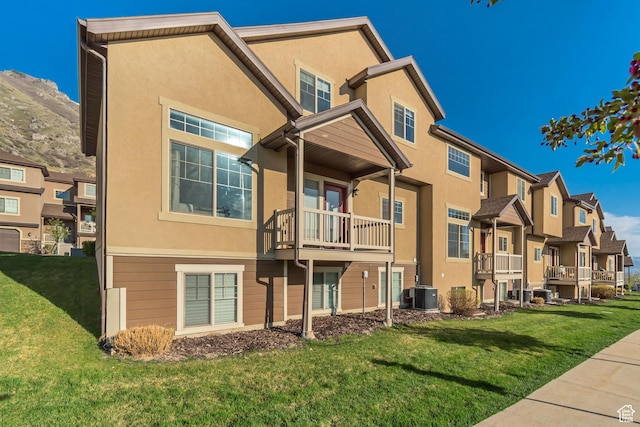 view of building exterior featuring cooling unit, a mountain view, and a residential view