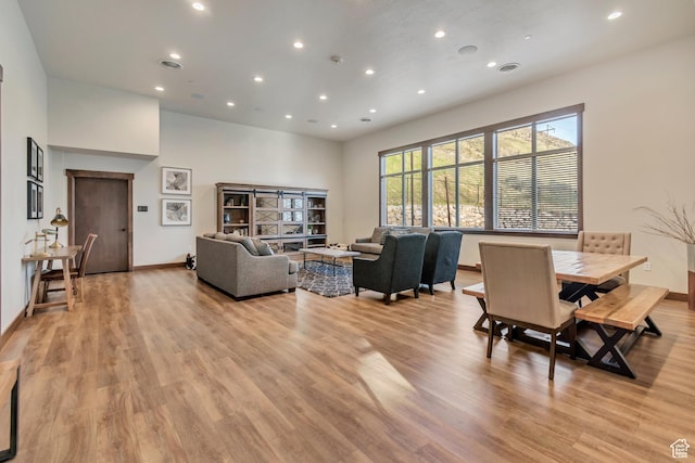 living room featuring recessed lighting, light wood-style flooring, baseboards, and visible vents