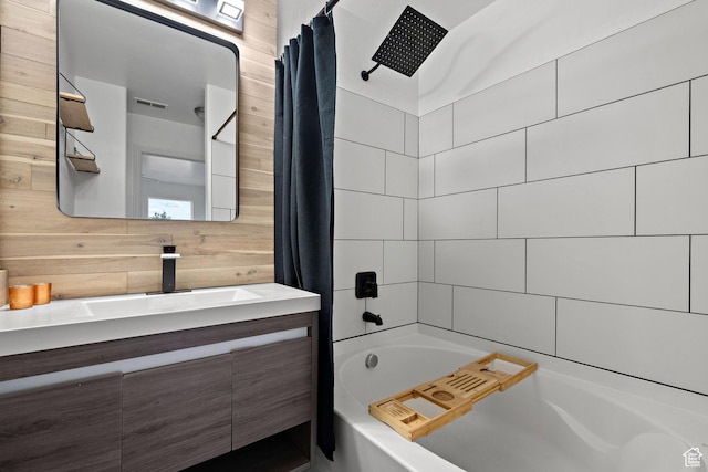 full bath featuring wood walls, shower / bathtub combination with curtain, vanity, and visible vents