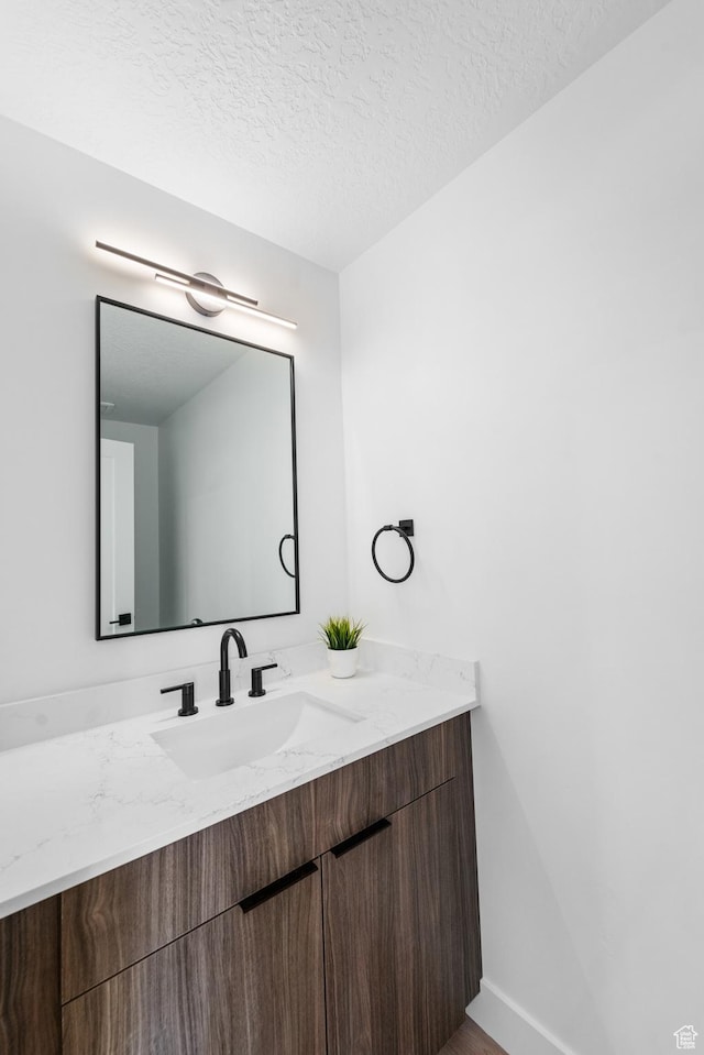 4372 S 900 E Unit 102, Millcreek, UT 84124 - bathroom featuring a textured ceiling and vanity