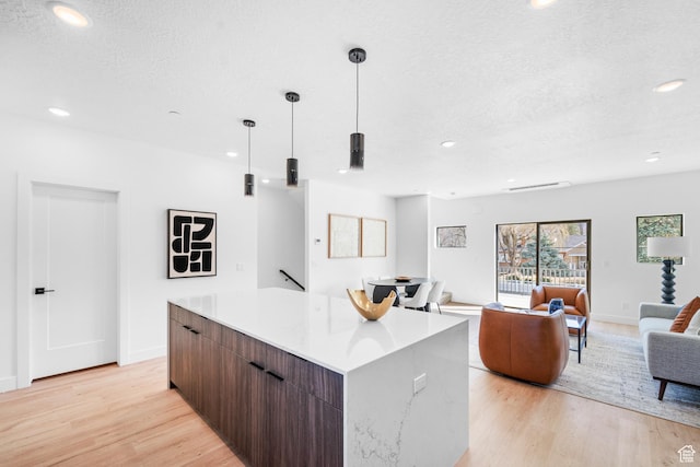 4372 S 900 E Unit 102, Millcreek, UT 84124 - kitchen with a center island, a textured ceiling, modern cabinets, light wood-style flooring, and recessed lighting
