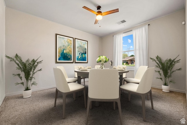 dining space with visible vents, baseboards, a ceiling fan, and carpet floors