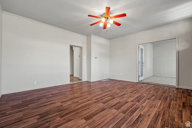interior space with ornamental molding, ceiling fan, wood finished floors, and baseboards
