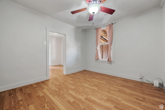 spare room with light wood finished floors, baseboards, crown molding, and ceiling fan