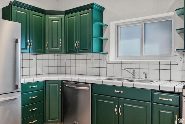 kitchen with tasteful backsplash, open shelves, stainless steel appliances, tile countertops, and a sink