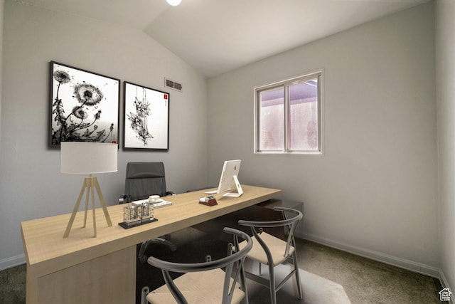 office space with baseboards, dark colored carpet, vaulted ceiling, and visible vents