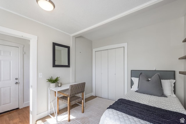 3752 S Mccall St E, South Salt Lake, UT 84115 - bedroom featuring wood finished floors, ornamental molding, baseboards, and a closet