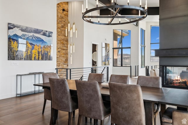 1526 W Orion Way, Heber City, UT 84032 - dining area featuring a towering ceiling, an inviting chandelier, a multi sided fireplace, and wood finished floors