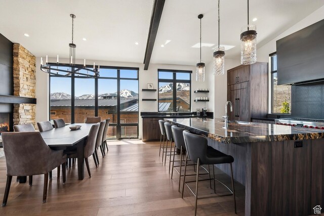 1526 W Orion Way, Heber City, UT 84032 - kitchen featuring a breakfast bar, extractor fan, a large island, wood finished floors, and modern cabinets