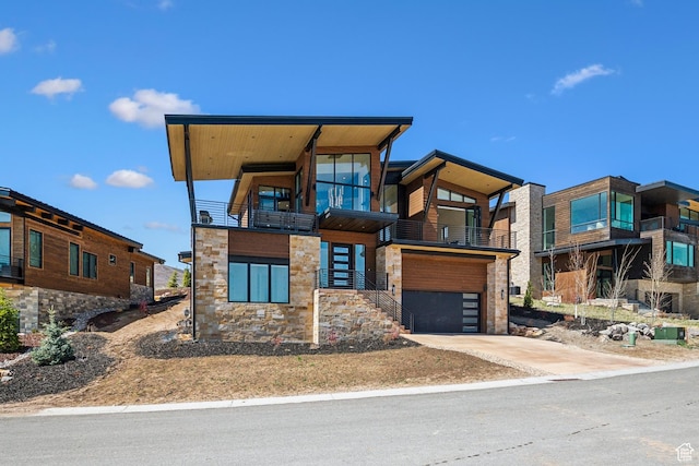 1526 W Orion Way, Heber City, UT 84032 - modern home with a garage, a balcony, concrete driveway, and stone siding