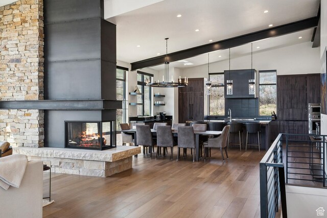 1526 W Orion Way, Heber City, UT 84032 - living room featuring wood finished floors, lofted ceiling with beams, plenty of natural light, and a multi sided fireplace