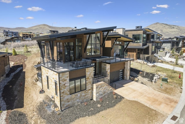 1526 W Orion Way, Heber City, UT 84032 - exterior space featuring concrete driveway, a balcony, stone siding, a mountain view, and an attached garage