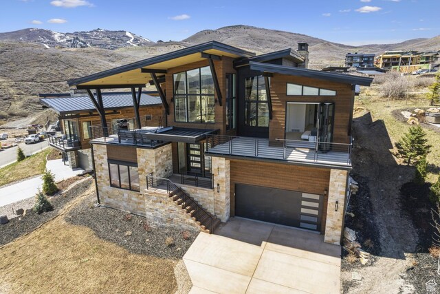 1526 W Orion Way, Heber City, UT 84032 - view of front of property featuring a mountain view, stone siding, an attached garage, and concrete driveway