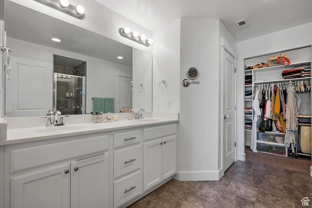 4444 W Lone Shadow Ln, Herriman, UT 84096 - full bathroom with a sink, visible vents, double vanity, and a stall shower
