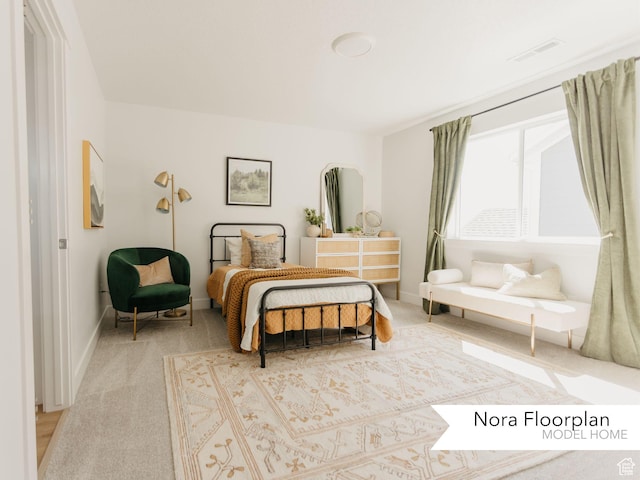 carpeted bedroom featuring baseboards and visible vents