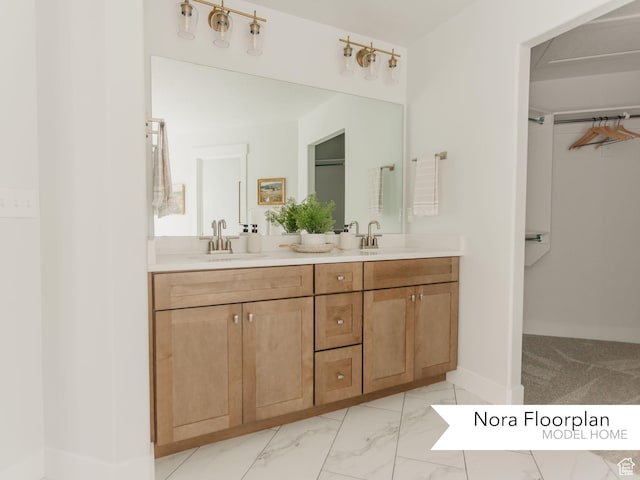 bathroom with baseboards, double vanity, marble finish floor, and a sink