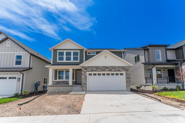 3889 W 950 N Unit 366, Lehi, UT 84043 - view of front facade featuring a porch, concrete driveway, stone siding, and a garage