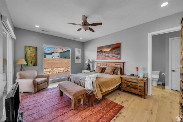 bedroom featuring visible vents, ensuite bathroom, ceiling fan, light wood-type flooring, and recessed lighting