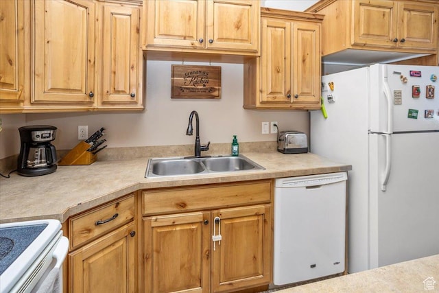 kitchen featuring a sink, light countertops, and white appliances
