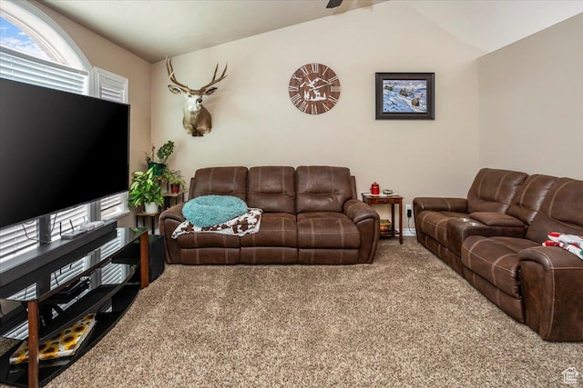 carpeted living area with vaulted ceiling