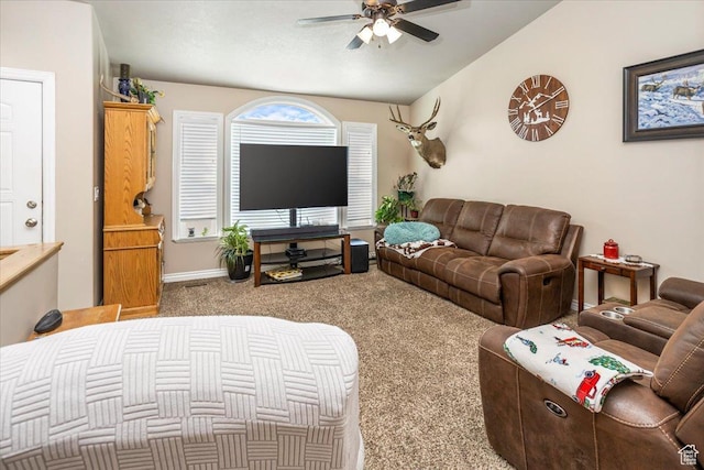 carpeted living room with ceiling fan and lofted ceiling