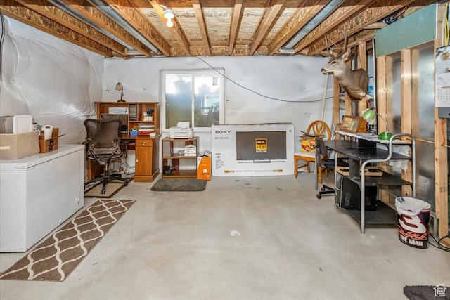 unfinished below grade area with refrigerator