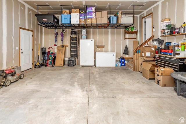 garage with white fridge and freestanding refrigerator