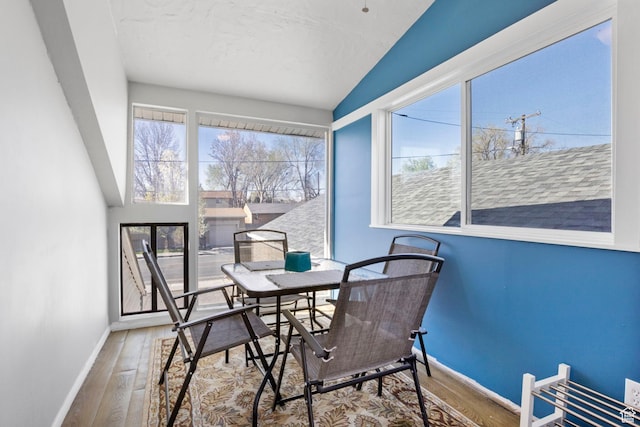 dining room with baseboards, a wealth of natural light, and wood finished floors