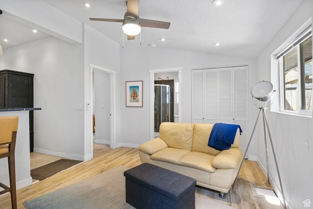 living area featuring baseboards, light wood-type flooring, recessed lighting, a ceiling fan, and lofted ceiling