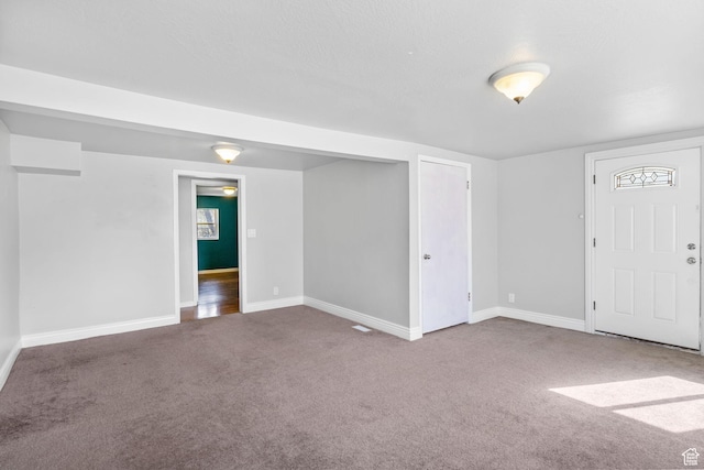 interior space featuring baseboards and carpet