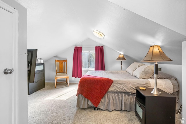 carpeted bedroom featuring lofted ceiling