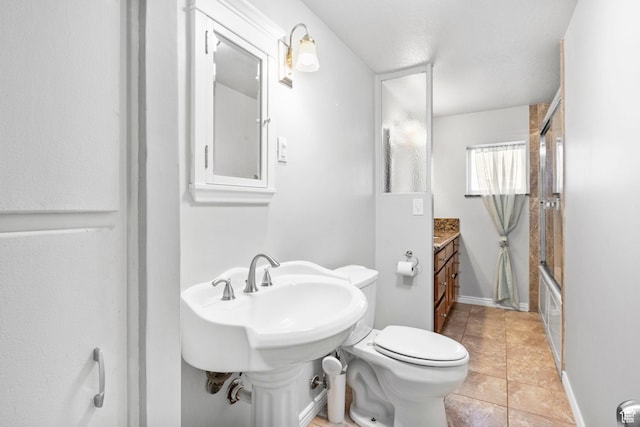 bathroom featuring toilet, tile patterned flooring, and bath / shower combo with glass door
