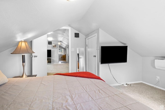 unfurnished bedroom with a wall mounted AC, baseboards, vaulted ceiling, and carpet floors
