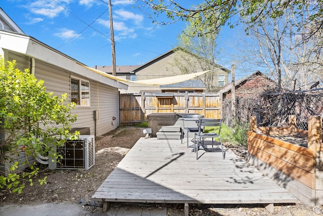 wooden terrace featuring fence and a hot tub