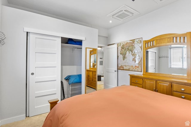 bedroom featuring visible vents, a closet, and light carpet