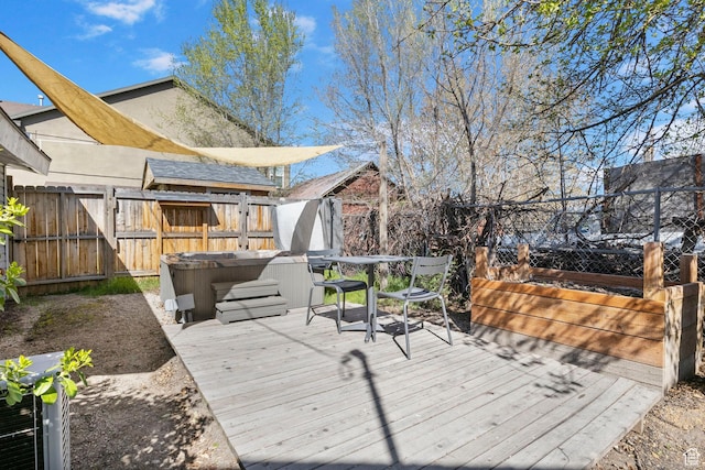 wooden terrace with fence and a hot tub