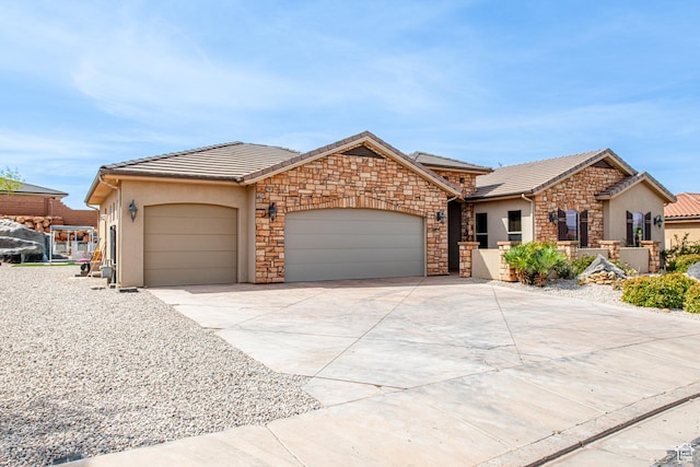 ranch-style home featuring a tile roof, driveway, a garage, and stucco siding
