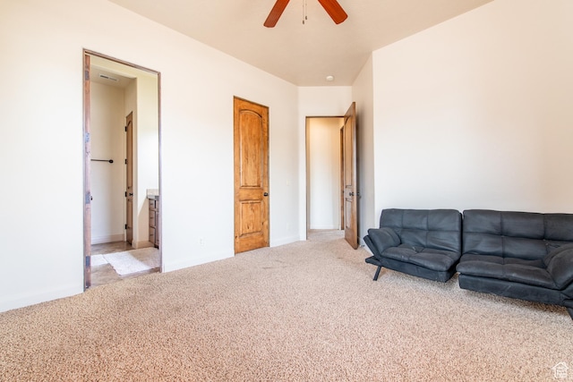 carpeted living room with ceiling fan and baseboards