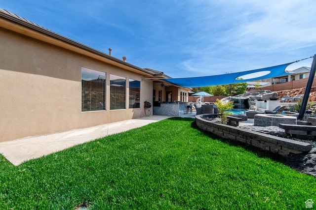 view of yard featuring a patio, a fire pit, and a fenced backyard