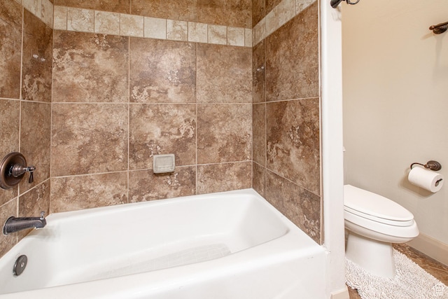 full bath with baseboards and toilet