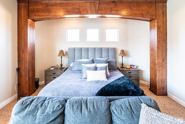 carpeted bedroom featuring baseboards