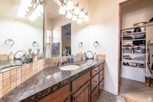 bathroom with a spacious closet and vanity