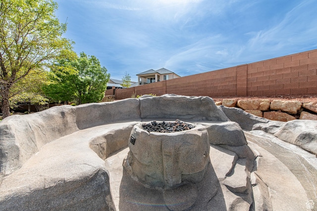 details featuring a fenced backyard and a fire pit