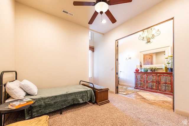 carpeted bedroom featuring visible vents, baseboards, and a ceiling fan